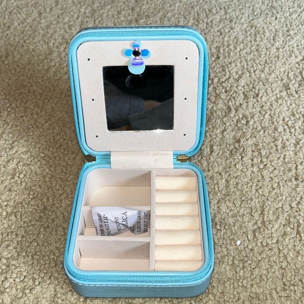 Small travel jewelry case.  Light blue.  Has mirror